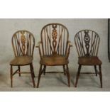 A harlequin set of three late 19th century wheel back Windsor chairs, including a carver and a