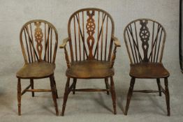 A harlequin set of three late 19th century wheel back Windsor chairs, including a carver and a