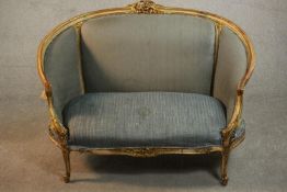 A Louis XV style giltwood canape sofa, with carved cresting and upholstered in blue fabric, with