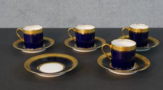 A Limoges royal blue and gilded porcelain five person part coffee set. Each piece with a relief gold