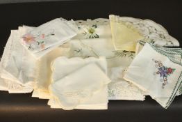 A collection of early 20th century table linen some with hand embroidered details and lace