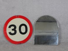 A 30 mile an hour speed limit enamel sign along with an arched bevelled plate wall mirror. Diam.60cm