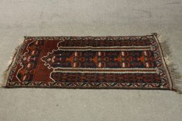 A hand made black ground Belouch rug. L.140 W.75cm.