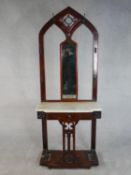 A Victorian Gothic Revival walnut hallstand, of arched form with a pierced panel centred by a