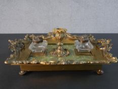A 19th century gilt bronze Rococo style foliate design and green alabaster desk stand with