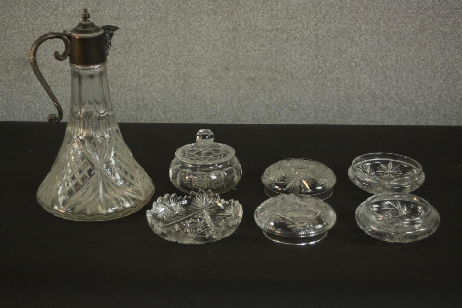 A silver plated claret jug along with other cut crystal items. H.30 Dia.17cm. (largest)