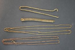 A collection of rolled Victorian chains, including two rolo link long watch chains with Albert