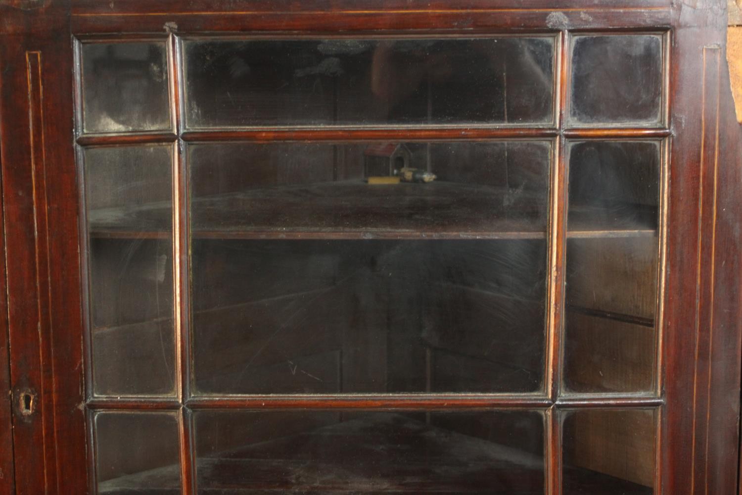 A George III mahogany corner cabinet, with a glazed door enclosing shelves. H.74 W.78 D.41cm. - Image 3 of 8