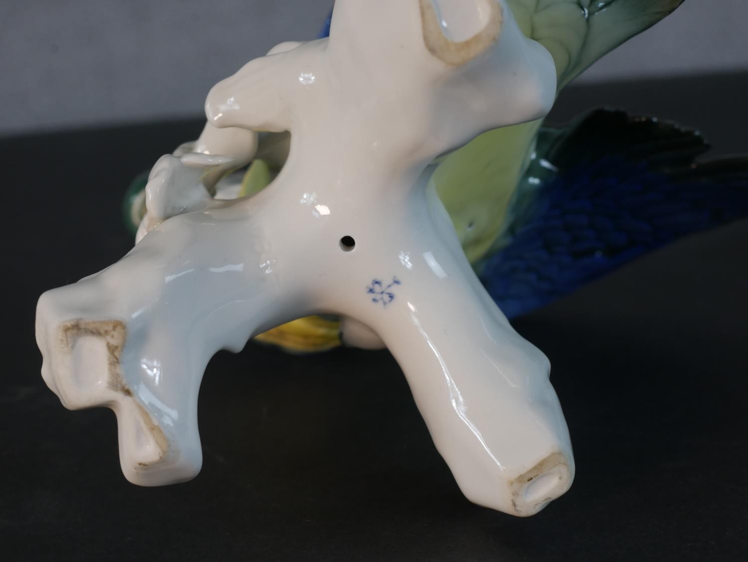 A Karl Ens porcelain blue and yellow parrot perched on a leafy branch, blue printed factory mark - Image 5 of 5