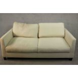 Meridiani, Italy; a contemporary two seater sofa with loose back and seat cushions, upholstered in