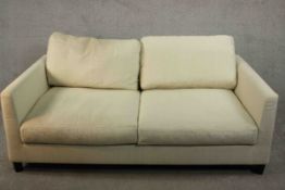 Meridiani, Italy; a contemporary two seater sofa with loose back and seat cushions, upholstered in