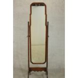 An early 20th century walnut cheval mirror, of slender form on splayed legs. H.160 W.40 D.45cm.