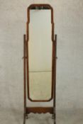 An early 20th century walnut cheval mirror, of slender form on splayed legs. H.160 W.40 D.45cm.