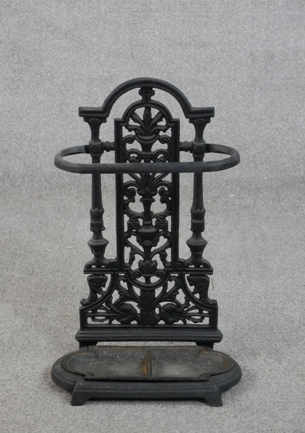 A 19th century black painted cast iron umbrella stand, with a removable drip tray. H.53 W.33 D.15cm