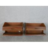 A pair of circa 1960s teak wall mounted bedside tables, the shelf over a single drawer above another