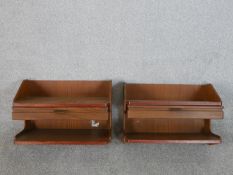 A pair of circa 1960s teak wall mounted bedside tables, the shelf over a single drawer above another