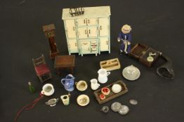 A collection of Victorian dolls house accessories, including a painted kitchen cabinet with