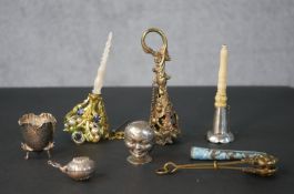 A collection of three early 20th century posy holders, one with a silver trumpet and horn handle,