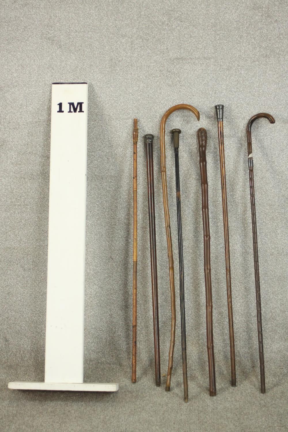 A collection of seven early 20th century walking canes, two with silver tops. L.90cm. (longest) - Image 2 of 4