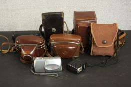 A collection of seven vintage 35mm cameras and others. Makers include Kodak, Olympus, Paxette,