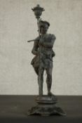 An early 20th century spelter figure of a man holding a flower on a stylised foliate form base. H.43