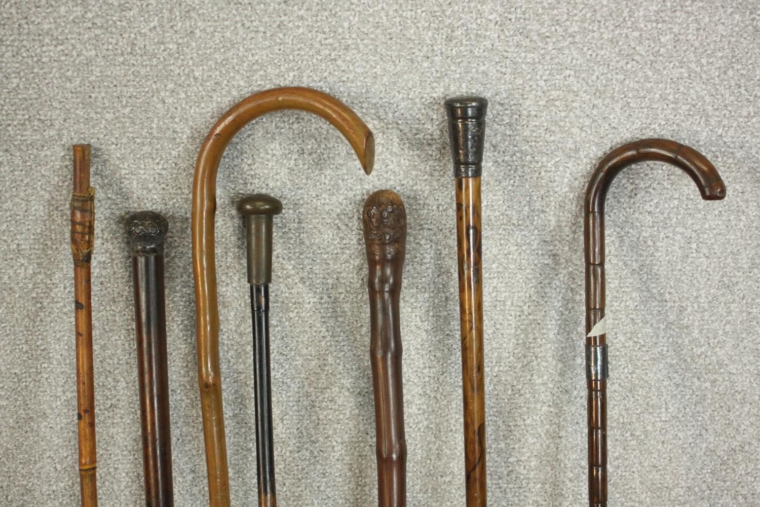 A collection of seven early 20th century walking canes, two with silver tops. L.90cm. (longest) - Image 3 of 4