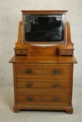 A late Victorian dressing chest, with a rectangular bevelled mirror over two small drawers, above