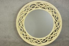 A large contemporary circular cream painted mirror, with a bevelled mirror plate, the frame with