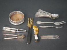 A collection of silver plated and horn cutlery, including a wine coaster, horn fork and butter