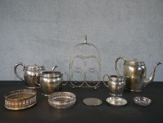 A collection of silver plated items, including a four pieces engraved coffee set, a wine rack, two