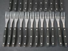 A Rostfrei Inox twelve person part black handled steak set with stainless steel blades and tines. (