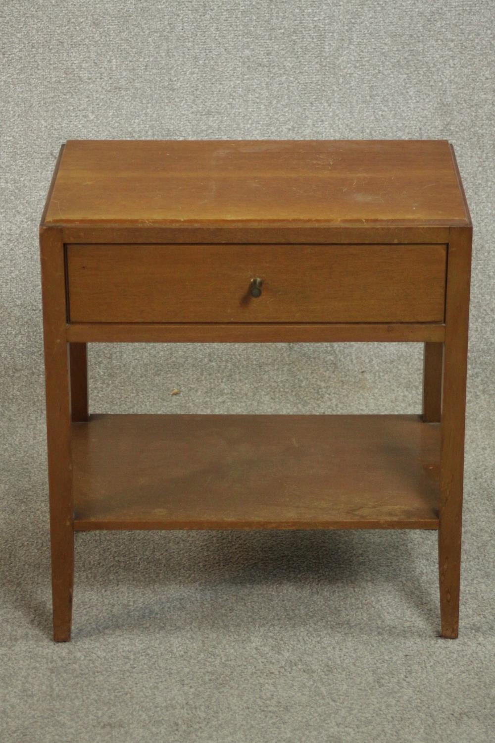 A mid 20th century Heal's style oak bedside table, with a single drawer over an undertier on