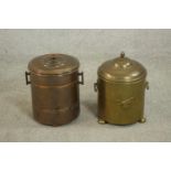 A brass coal bucket and a copper coal bucket, both of cylindrical form with a lid and two handles.