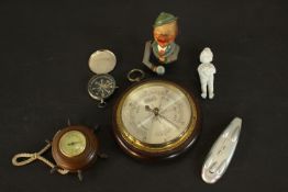 Two barometers, a vintage compass, bisque porcelain figure and a Bavarian painted nut cracker. H.3