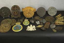 A collection of about twenty gilded metal, brass and painted cast iron plaques, locks and cabinet