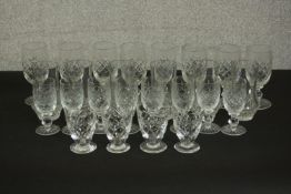 A collection of cut crystal drinking glasses, including four cut glass port glasses, a set of