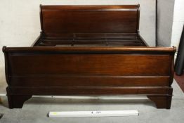 A contemporary French style mahogany double sleigh bed with slats. H.96 W.127 D.185cm.