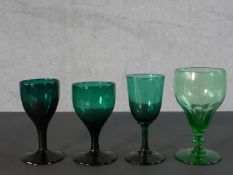 Three Victorian Bristol green wine glasses along with a 19th century pale green petal faceted glass.