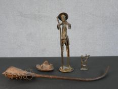 A collection of African tribal items, including a Dejembe iron rattle, a sculpted clay African