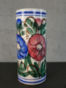 A Spanish majolica pottery umbrella stand hand painted with a colourful floral design. Signed to the