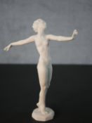 A Hutschenreuther bisque porcelain figure by Carl Werder, a nude dancing woman with arms