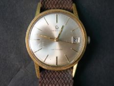 A gold plated vintage Certina Certidate automatic wristwatch with brown fabric strap.