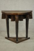 An Indian hardwood demi lune side table, raised on three carved elephant head legs on a triangular