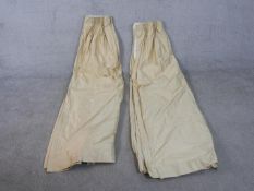 A pair of heavy silk mix cream fully lined curtains. L.250 W.190cm