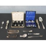 A collection of silver and silver plated cutlery, including a cased set of shell design coffee