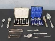 A collection of silver and silver plated cutlery, including a cased set of shell design coffee