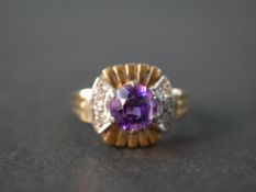 A vintage 14 carat white and yellow gold amethyst and diamond dress ring, set to centre with a round