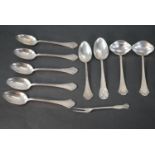A collection of Danish silver cutlery, including six Danish scrolling design spoons and two sauce