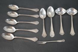 A collection of Danish silver cutlery, including six Danish scrolling design spoons and two sauce