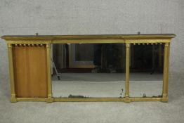 A Regency giltwood inverted breakfront triple plate overmantel mirror, with ball frieze and column
